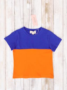 Stay stylish with this family-friendly collegiate set! Our Blue & Orange Shirt comes in a fresh color block design and is perfect for any family outing. Get your matching set now and show your sports-themed pride! Shop all Collegiate Wear here! Fits true to size. Unisex fit. 97% Cotton / 3% Spandex Import. Leeha is 5’4” & 180lbs wearing size XL. Tyson is 24 lbs & 29 inches tall wearing size XS (18-24 months). Spencer is 5’8” & 190lbs wearing size M. Alyssa is 5’3” & 160lbs wearing size L. **Afte Blue Cotton T-shirt With Contrast Stripes, Blue Sporty T-shirt With Contrast Stripes, Playful Multicolor Color Block T-shirt, Sporty Multicolor Color Block T-shirt, Spring Color Block Short Sleeve T-shirt, Orange Cotton T-shirt For Game Day, Summer Blue T-shirt With Contrast Stripes, Casual Blue Tops With Contrast Stripes, Sporty Solid Color Tops For Playwear