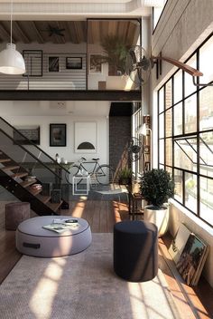 a living room filled with lots of furniture next to a stair case in front of a window