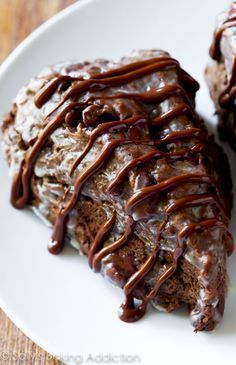 two pieces of cake with chocolate drizzled on top