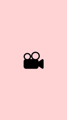 a pink background with an image of a camera and some glasses on top of it