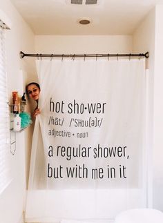 a bathroom with a shower curtain that has words on it