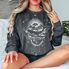 This is the perfect sweatshirt for the sun and moon lover! This makes a wonderful and unique sweatshirt to wear throughout the year! This celestial whale sweatshirt is great paired with your favorite jeans! This sun and moon design is perfect on the popular Gildan brand sweatshirt. This simple style sweatshirt will keep you warm throughout the fall and winter season!  Snuggle up with your favorite book in this cozy sweatshirt. It's made with 80% ring-spun cotton and 20% polyester and the fabric is 3-end garment-dyed, ring-spun, color-blast fleece with a 100% cotton face. Each sweatshirt comes with a relaxed fit, a rolled-forward shoulder, and a back neck patch.  ** P R O D U C T ** - 80% ring-spun cotton, 20% polyester - Medium-heavy fabric  - Relaxed fit - Sewn in twill label ** S I Z I N Trendy Crew Neck T-shirt With Moon Print, Casual Short Sleeve T-shirt With Sun And Moon Design, Mystical Moon Shirt, Celestial Moon Print Crew Neck T-shirt, Bohemian Cotton T-shirt With Moon Print, Whale Shirt, Unique Sweatshirt, Moon Shirt, Nautical Gifts