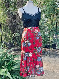 Elevate your vintage fashion collection with this Vintage Red Floral Long Skirt, a pretty and captivating piece that's sure to turn heads. This vintage skirt features a beautiful red floral pattern, a convenient zipper closure at the back, and a comfortable fit suitable for sizes small. Key Features: Vintage Elegance: This skirt captures the timeless charm of vintage fashion. Captivating Floral Pattern: The red floral pattern adds a touch of romantic allure to your ensemble. Easy Zipper Closure: Flowy Floral Print Rayon Skirt, Floral Print Rayon Midi Skirt, Fitted Red Maxi Skirt For Summer, Red Long Skirt For Spring, Red Flared Maxi Skirt For Summer, Bohemian Red Full Skirt, Red Fitted Floral Print Skirt, Red Fitted Skirt With Floral Print, Fitted Red Skirt With Floral Print