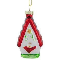 a glass christmas ornament with a bird on it's back and red trimming