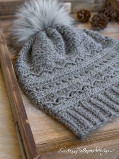 a knitted hat with a pom - pom on it