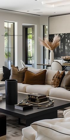 a living room filled with lots of furniture and pillows on top of a coffee table