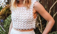 a woman wearing a white crochet crop top