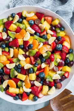 a white bowl filled with mixed fruit salad