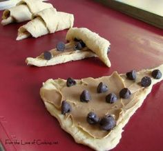 two pieces of chocolate chip pizza sitting on top of a red counter