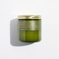 a green candle sitting on top of a white table