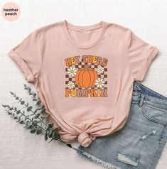 Hey There Pumpkin T-shirt, Retro Checkered Pumpkin Shirt, Thanksgiving Pumpkin Shirt, Pumpkin Season Gift Shirt, Hello Fall Pumpkin Shirt 🎈HOW TO ORDER 1-) Please, check and review all the photos. 2-) Choose your t-shirt size and color. *Different styles of shirts may have different shades of same color choice due to different manufacturer brands. *For this reason, we recommend you to match shirts from the same styles if you want precisely matching colors (ex. Unisex, V-necks, Toddler, etc.). 3 Pink Tops With Text Print For Fall, Pink Graphic Print Top For Fall, Retro Funny Print Fall T-shirt, Retro Fall T-shirt With Funny Print, Retro Tops With Funny Print For Fall, Retro Crew Neck Shirt For Fall, Fall Printed Cotton T-shirt, Fall Cotton Printed T-shirt, Printed Cotton T-shirt For Fall