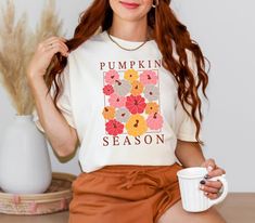 Celebrate the cozy vibes of autumn with our Pumpkin Season Comfort Colors Unisex T-Shirt. This vibrant design showcases a delightful array of colorful pumpkins, perfectly capturing the essence of fall. Whether you're heading to a pumpkin patch or enjoying a crisp fall day, this tee is a must-have addition to your seasonal wardrobe. **Product Details - **Material 100% ringspun cotton for a soft, breathable, and comfortable feel. - **Fit Relaxed unisex fit that looks great on everyone. - **Care In Colorful Pumpkins, Pumpkin Tshirt, Seasonal Wardrobe, Pumpkin Colors, Pumpkin Season, Pumpkin Seasoning, Fall Day, Cozy Vibes, Halloween Fall