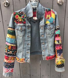 a denim jacket with colorful patches on it