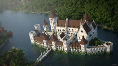 an aerial view of a castle on the water