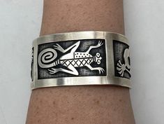 Absolutely incredible Hopi handmade cuff bracelet is made entirely of sterling silver with sterling silver overlay. The front/center of the cuff bracelet has a lizard, and the 2 sides of the cuff bracelet have kokopelli flute players (1 on each side). The amount of detail in the stampwork lizard and kokopelli designs is truly amazing!  Condition: Excellent! Artist: Signed JR Stamped/Marked: Sterling  Weight: 70 grams  Measurements: 6 inches around inside 1 1/2 inch wide gap  Fits a 6 1/2 to 7 1/ Handmade Custom Silver Bracelets, Custom Silver Handmade Bracelets, Handmade Sterling Silver Cuff Bracelet Collectible, Handmade Sterling Silver Cuff Bracelet For Collectors, Unique Silver Stamped Cuff Bracelet, Unique Adjustable Cuff Bracelet Stamped 925, Silver Cuff Bracelet With Stamped Details, Unique Adjustable 925 Stamped Cuff Bracelet, Unique Sterling Silver Cuff Bracelet Collectible