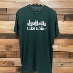 TAKE A HIKE T-SHIRT | Take a Hike Graphic Tee Shirt | Vintage Shirt | Ultra Soft Graphic Tee | T-shirt Men | Cool Shirts ntroducing our "Take A Hike" tee - more than just a t-shirt, it's an invitation to embrace the great outdoors. This isn't your ordinary tee; it's a wearable ode to the spirit of adventure. Why You'll Love It: ✨ Comfort for the Journey: Crafted with your comfort in mind, this tee isn't just about fabric; it's your companion for every step of the hiking journey. 😊 Nature Lover's Choice: A t-shirt that speaks to your love for the outdoors. Perfect for those who find solace, joy, and adventure in the beauty of nature. 👕 Adventure-Ready Style: Whether you're hitting the trails or just want to carry the essence of nature with you, this t-shirt effortlessly blends comfort wit Take A Hike Shirt, Green Crew Neck T-shirt For Outdoor, Green Crew Neck T-shirt For Outdoor Activities, Crew Neck T-shirt With Letter Print For Hiking, Green T-shirt For Outdoor Activities, Green Graphic Tee For Hiking, Sporty Crew Neck T-shirt For Hiking, Green Short Sleeve T-shirt For Outdoor, Pre-shrunk Tri-blend T-shirt For Outdoor Activities