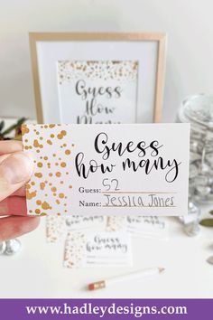 a person holding up a business card with gold confetti on it and the words guess how many