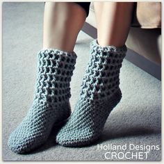 a woman's legs wearing crocheted gray socks