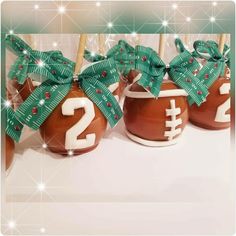 three chocolate covered candies with green bows and numbers on them for football themed treats