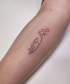 a person's arm with a small tattoo on the left side of their arm