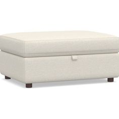 a white ottoman sitting on top of a wooden frame