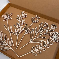 a box with some cut out flowers in it