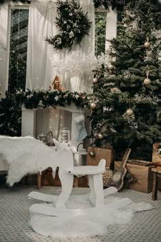 a white rocking horse sitting in front of a christmas tree