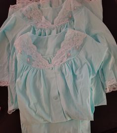 Lovely pajama and robe matching set in light blue with Chantilly lace, rose appliques and pockets on top and robe. Wake up in the mornings in this set of  PJ's and robe or in the evening as a lounge set.  Size: Medium Set: Shirt and Pants & Robe Material: Nylon Condition: Overall very good vintage condition.  Vintage linens are at least 20-50 years old and therefore; some items may have a few minor imperfections.  If you have any questions about this item, please let me know and I will do my bes Long Sleeve Sleepwear With Lace Trim For Loungewear, Long Sleeve Sleepwear With Lace Trim For Pajama Party, Light Blue Cotton Sleepwear For Home, Light Blue Cotton Sleepwear, Long Sleeve Lace Trim Sleepwear, Cotton Sleep Sets With Lace Trim, Long Sleeve Lace Trim Sleepwear For Sleepovers, Long Sleeve Nightgown With Lace Trim For Sleepover, Cotton Loungewear Sets With Lace Trim