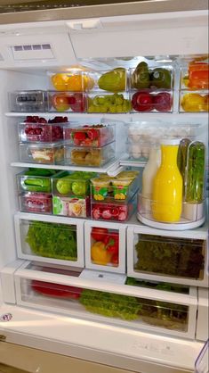 an open refrigerator filled with lots of different types of vegetables and fruit in it's doors