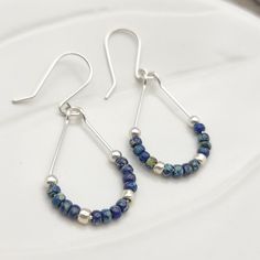 . Beautiful Sterling Silver Teardrop Hoop Earrings with Denim Blue Miyuki Seed Beads.   These are dainty while making a statement, and would look great dressing up a simple T-Shirt, or could be a stunning addition to wedding and bridesmaid jewelry. ~ .925 Sterling Silver ~ Measure approximately 1.5 Inches ~ Blue Miyuki Seed Beads ~ Sent in a Ribboned Gift Box ~ Handmade in Montana Blue Teardrop Hoop Earrings With Dangling Beads, Blue Beaded Drop Earrings For Everyday, Everyday Blue Beaded Drop Earrings, Adjustable Blue Teardrop Hoop Earrings, Nickel Free Blue Teardrop Beaded Earrings, Blue Teardrop Earrings With Dangling Beads, Blue Teardrop Hypoallergenic Hoop Earrings, Blue Hypoallergenic Teardrop Hoop Earrings, Everyday Blue Teardrop Hoop Earrings