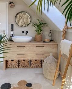 a bathroom with a sink, mirror and potted plants