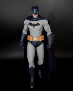 the batman action figure is posed on a black background