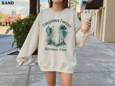 This Forbidden Forest National Park wizard sweatshirt is super soft and cozy. Perfect to lounge around, run errands, or walk your dog. ABOUT THIS SHIRT   ∙ Shirt is UNISEX and runs slightly large for ladies (For a relaxed fit, I suggest your usual size. For an oversized fit, I suggest sizing up 1 to 2 sizes.) ∙ 50% cotton, 50% polyester blend fabric ∙ Colors may vary based on your monitor/screen display or lighting CARE INSTRUCTIONS ∙ Machine wash inside out in cold water ∙ Tumble dry medium or Mountain Sweater, Montana Sweatshirt, California Sweater, California Sweatshirt, National Park Shirt, Beach Sweater, Vintage Pullovers, Backyard Chickens, Vintage Souvenir