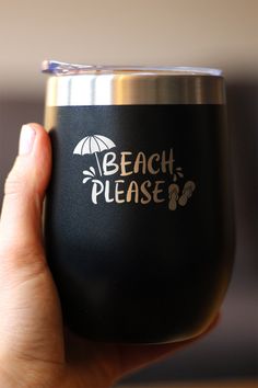 a person holding up a wine glass with the words beach please on it