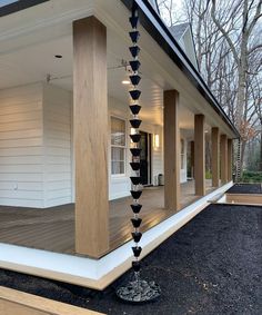 an outside view of a house with wooden pillars and columns on the front porch area