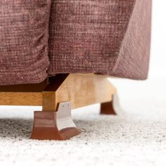 a close up view of the back end of a couch with its foot on it