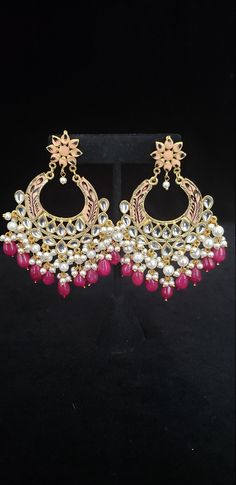 "This beautiful Kundan earrings set has an excellent finish and gives out an exquisite sense of style. If you are looking for an amazing Fashion Jewelry set for special occasions such as Anniversary, Engagement, Party, Wedding, gifting, then your search ends here. This handmade Indian Jewelry is best to wear for traditional ceremonies or Indian weddings. This bridal jewelry has an ethnic finish. It has Cubic Zircon stones with semi-precious ruby and emeralds. It is a Bollywood style one-gram jew Festive Pearl Dangle Earrings With Beads, Elegant Danglers With Dangling Beads For Festivals, Elegant Danglers With Beads For Festivals, Elegant Festival Danglers With Beads, Elegant Kundan Danglers With Dangling Beads, Elegant Kundan Danglers With Beads, Traditional Chandbali Earrings With Dangling Beads, Traditional Chandbali Jewelry With Dangling Beads, Traditional Pearl Drop Hoop Earrings For Wedding