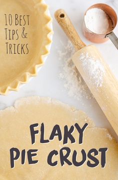 the words flaky pie crust are written in black ink on top of floured dough