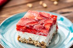 a piece of cake with strawberries on top is sitting on a blue and white plate