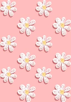 some white flowers on a pink background with yellow centers and petals in the center, as if they were cut out from paper