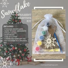 the snowflake ornament painting kit includes 3 wood ornaments, 4 paint brushes, 2 paintbrushes, and a christmas tree