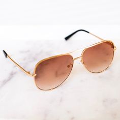 Our Alexa Aviator Frame Sunglasses are the staple trendy sunglasses of the season. Designed in a large aviator frame and available in either a black or ombre brown tinted shade. Throw these in your bag for the perfect minimal vacation or summer accessory. Each pair comes with its own soft-cloth case. Ombre Brown, Round Frames, Rose Boutique, Trendy Sunglasses, Brown Ombre, Fall Accessories, Summer Accessories, Colored Sunglasses, Glasses Accessories