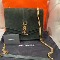 Authentic Ysl Sulpice Green Suede Bag In Excellent Condition No Rips Or Stains Smoke/Pet Free Home Comes With Bag I Don’t Have The Box I Can’t Find It But It Has Been In The Storage Bag I Only Used It About 6 Times Also Clean On The Inside Thanks For Looking Ysl Suede Bag, Ysl Sunset Bag Green, Sage Green Ysl Bag, Luxury Shoulder Bag With Suede Lining For On-the-go, Luxury Suede Bags For On-the-go, Yves Saint Laurent Bags, Green Suede, Bag Storage, Yves Saint Laurent