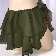 a close up of a mannequin wearing a green top with ruffles