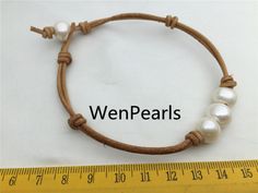 "Bracelet is 6''-10.5'' long. Leather is 2 mm thick. Front have three round pearl, size is 11-12mm, this pearl is big,and good quality Back to Other Jewelry Section 01: \"Tahitian,Akoya,Sea Pearl\" Section: https://www.etsy.com/shop/WenPearls?section_id=15806339 02: \"Potato/Near Round Pearl\" Section: https://www.etsy.com/shop/WenPearls?section_id=16378067 03: \"Round Pearl\" Section: https://www.etsy.com/shop/WenPearls?section_id=16163245 04: \"Rice/Oval/Teardrop Pearl\" Section: https://www.e Leather Pearl Bracelet, Leather Pearl Jewelry, Leather Pearl Necklace, Big Pearl, Freshwater Pearl Bracelet, Pearl Leather, Pretty Bracelets, Keshi Pearls, Sea Pearls