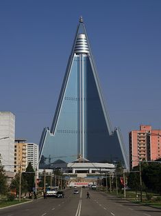 a very tall building sitting on the side of a road