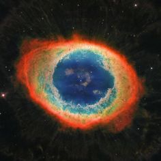 an image of a very colorful object in the sky with stars around it and blue, green, red and yellow colors