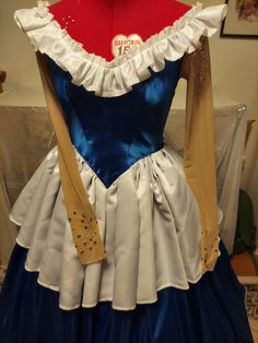 This was made for a Christmas parade in 2022. It was worn for 2 hours and then it went right into storage.  The costume is very fun to wear and it should be worn over a nice puffy crinoline.  The fabric consists of blue shiny satin and a white matte satin. The edges are decorated with a sparkly stiff lace type ribbon. The back closes with a zipper and only the bodice is lined. The sleeves are made of a flesh toned power mesh. They are decorated with flat back faux crystals and also preciousa tea Princess Style Victorian Dress With Ruffles For Costume, Ruffled Ball Gown Princess Dress For Costume Party, Princess Costume With Ruffles For Fancy Dress, Princesscore Ruffled Princess Dress For Costume, Blue Victorian Dress With Ruffles For Fancy Dress, Blue Fairytale Costume For Costume Party, Fairytale Blue Costumes For Costume Party, Blue Ruffled Princess Dress For Costume Party, Blue Victorian Dress With Ruffles For Costume