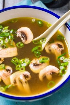 a bowl of soup with mushrooms and green onions