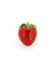 a red strawberry sitting on top of a white surface